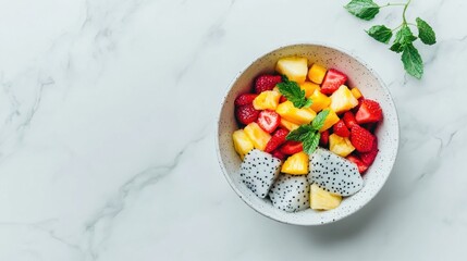 Fresh Fruit Salad with Dragon Fruit and Mint on Marble Table