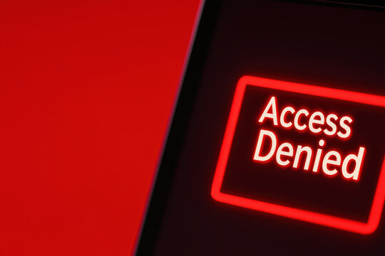 Access denied message displayed on laptop screen with red background, conveying sense of restriction and urgency