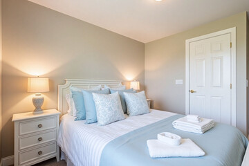 Bedroom muted palette blue duvet bedside lamp cozy