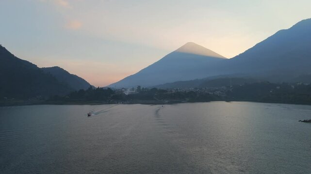 Panoramic shot of Lake Atitl&aacute;n under a cloudy sunset, appreciating the mountains surrounding the lake