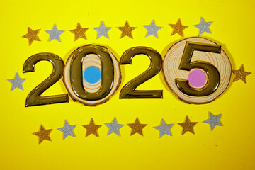 golden numbers 2025 two thousand twenty five new year with colorful stars confetti on yellow...