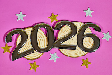 golden numbers 2026 two thousand twenty six new year with colorful stars confetti on wooden trunk
