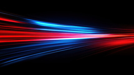 Long exposure photograph of blue and orange light trails on the road, against a black background