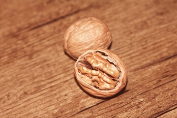 A whole walnut, an open walnut with a wooden background. wo