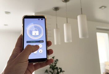 Smart house, home automation, device with App icons. Man uses his smartphone with smarthome app to control the lights of his house.