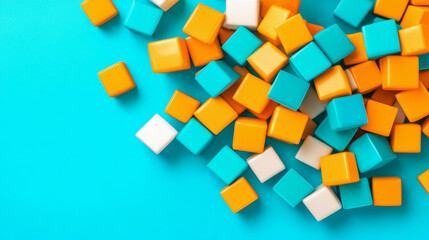 Obraz premium Colorful building blocks scattered on bright blue background create playful atmosphere