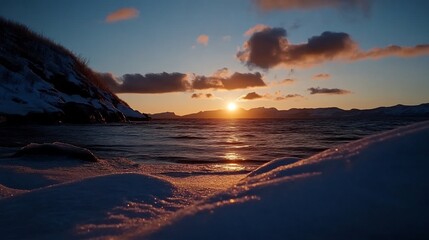 Fototapeta premium Stunning Sunset over a Snowy Coastline in Winter