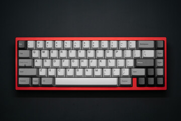 Close-up top view of a red mechanical keyboard with greyscale keycaps, captured in a flat lay style. Positioned in center of the frame, on a matte black surface. © awiaes