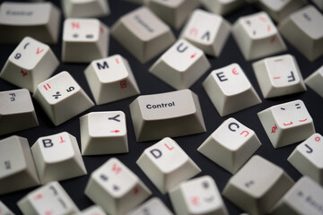 Close up scattered white keycaps with control keycap focus. Black on white mechanical keyboard...