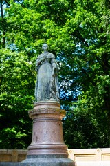 Fototapeta premium A bronze statue of Grand Duchess Charlotte stands in a park in Luxembourg City. The statue was created by Luxembourgish sculptor Auguste and was inaugurated in 1930.