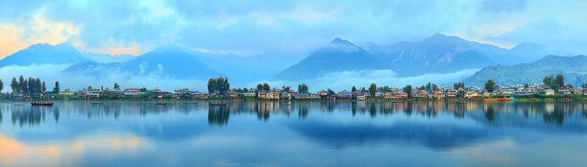 Naklejka premium Scenic view of mountains reflected in tranquil lake waters.
