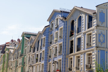 Obraz premium Facade of Colorful Houses. Residential buildings. Bright windows. Blue green modern architecture. Exterior