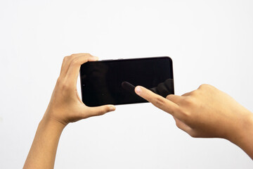 Hand holding smartphone with blank screen isolated on white background