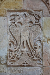 A historical building framed with artistically carved stonework. Architectural detail from the Divriği Great Mosque and Hospital, listed on the UNESCO World Heritage List. Floral and geometric motifs.
