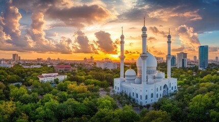 Sunset panoramic view of a white mosque in a city.