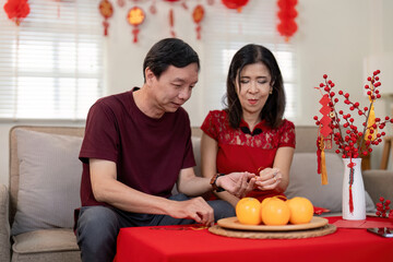 Elderly couple celebrates chinese new year with traditions at home festive decor intimate atmosphere joyful moments