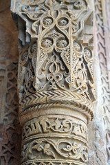 A historical building framed with artistically carved stonework. Architectural detail from the Divriği Great Mosque and Hospital, listed on the UNESCO World Heritage List. Floral and geometric motifs.