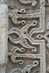 A historical building framed with artistically carved stonework. Architectural detail from the Divriği Great Mosque and Hospital, listed on the UNESCO World Heritage List. Floral and geometric motifs.