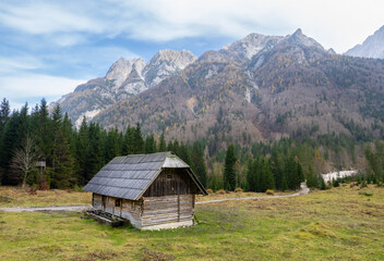 Drone aerial of wooden mountain hut overlooking valley julian alps, slovenia.