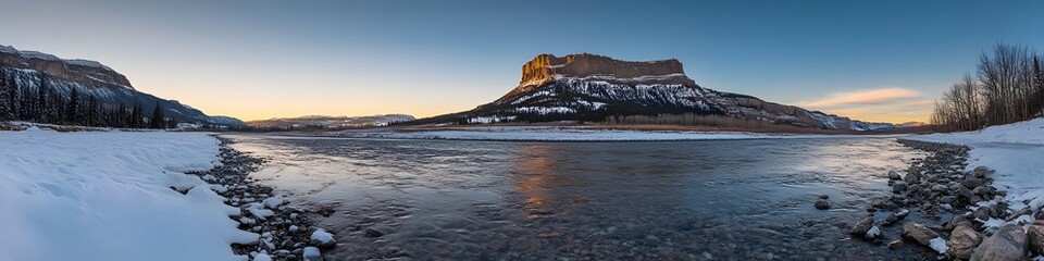 Obraz premium Wide-angle shot of Castle Mountain glowing under the warm hues of sunset. with the Bow River flowing peacefully below. in 4K resolution