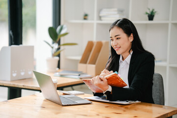 Asian business woman Working at the office with documents on the table Planning to analyze financial reports business plan investment financial analysis concepts