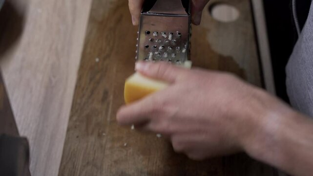grating cheese on the wooden board