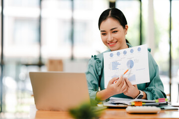 Businesswoman working on laptop at desk in office