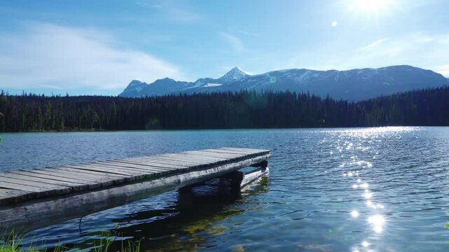 Wooden dock on the lake shore. Leach Lake, Jasper National Park. Alberta, Canada. Canadian Rockies summer landscape.