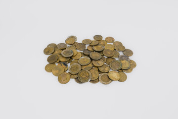 A collection of coins scattered and isolated on a white background. Concept of money saving and investment, business finance, taxes, and banking.