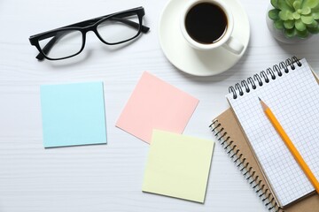 Workplace with stickers, glasses and coffee cup, top view