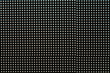 Blurred photo of video wall screen on black background with pixel grid layout for digital panel LED display with mesh diodes.
