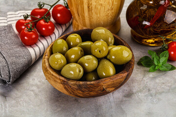 Big green marinated olives in the bowl