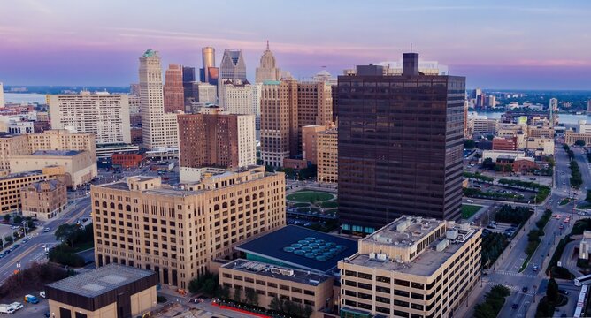 Aerial view of Detroit's downtown skyline at twilight, showcasing a mix of modern and historic architecture, including the DTE Energy building. DOWNTOWN, DETROIT, MICHIGAN, UNITED STATES