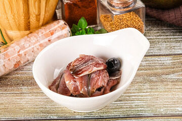 Canned anchovy with oil in the bowl
