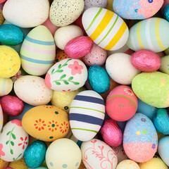 Easter egg background  colorful large collection of decorated and foil wrapped eggs. Edible food symbols for holiday season for greeting card.