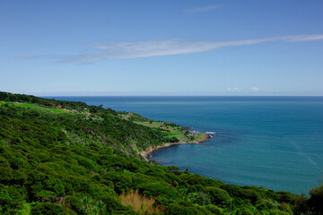 Panoramic view over high coast of Tasman Sea on an overcast summer day. High vantage point. Raglan, New Zealand