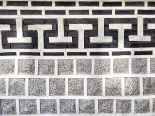 Geometric patterns of black and white bricks create a striking texture, offering a stylish backdrop with ample copy space.