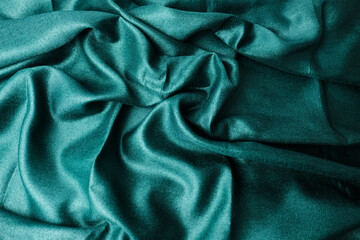 Abstract textured background with green grungy textile folds, perfect for design applications