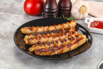 Grilled meat sausages wrapped bacon