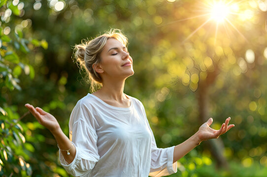 Woman doing breathing exercises with closed eyes and raised hands, relaxing on nature. Calm girl enjoying fresh air, meditation with breathing, healthy yoga. Deep breath through nose for brain