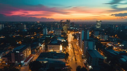 Fototapeta premium Aerial view of a bustling cityscape glowing under twilight skies