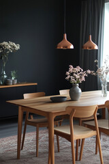 A light oak dining table and chairs sit against a soft beige wall, complemented by a minimal white countertop kitchen. The mid-century Scandinavian home 