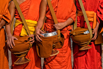 Buddhist monks in a line in Luang Prabang, Laos. Travel, Traditions and Culture