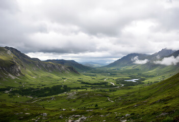 Obraz premium A lush green valley surrounded by rugged mountains under a dramatic cloudy sky