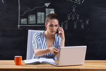 Photo of beautiful young woman at workplace