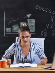 Young woman is worried and nervous at workplace.