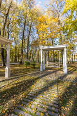 A path in a park with a bench and a gazebo
