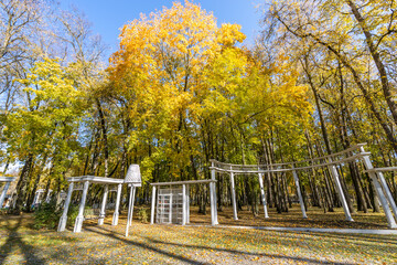 A park with a white gazebo and a white bench