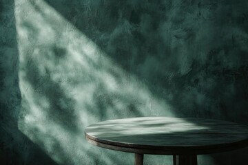 Empty table on dark green texture wall background. Composition with organic shadow on the wall and light reflections. Mock up for presentation, branding products, cosmetics food or jewelry. 
