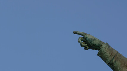 Main de statute qui poite vers la gauche